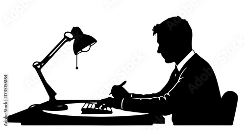 Diligent businessman focused on work at his desk, typing and writing under a bright lamp, symbolizing productivity and dedication in a modern office.