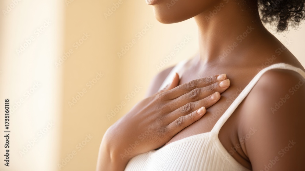 Fototapeta premium Inner Peace: A serene and candid shot of a person tenderly placing a hand over their heart, suggesting a sense of calm and introspective reflection.