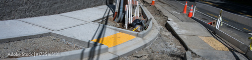 Public road construction project, new sidewalk and retaining wall, ADA accessible access on corner curb
