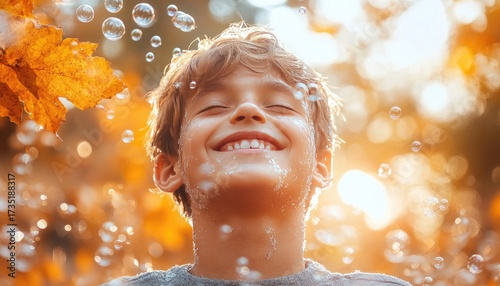 Smiling boy with closed eyes and bubbles, bright light, and an autumn leaf. It can represent pure joy, childhood wonder, or peaceful relaxation.