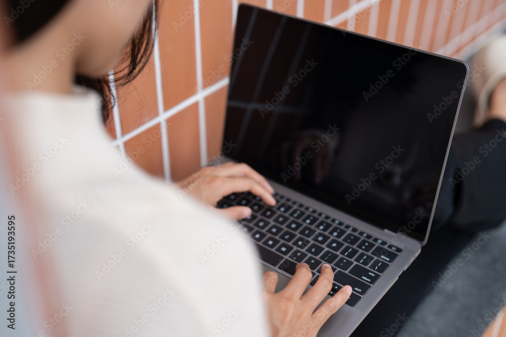 Fototapeta premium University Young Asian Woman Student Reviewing Lessons Alone with laptop at Campus Building.