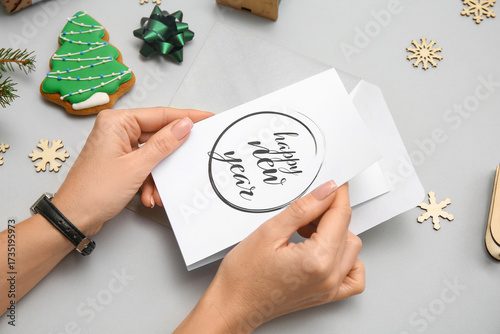 Woman holding greeting card...