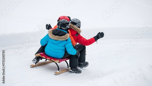 Three people bundled in winter coats ride a wooden sled across a snowy expanse.
