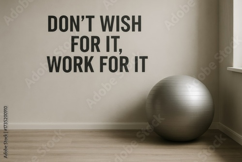 Motivational quote inspires perseverance in this clean fitness space. A silver stability ball sits ready for exercise sessions.