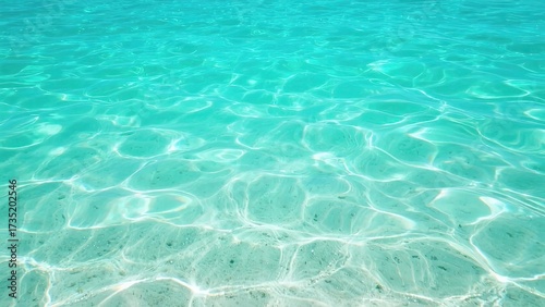Fototapeta Naklejka Na Ścianę i Meble -  Clear turquoise water with sunlight reflections and sandy bottom