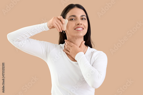 Young woman with gua sha ma...
