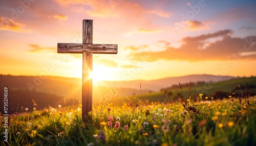 Wooden cross in a field at sunset