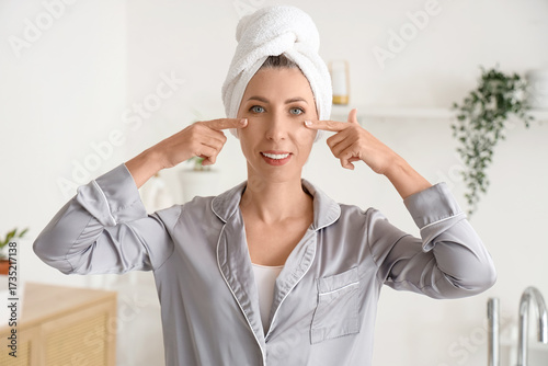 Smiling woman in pajamas an...