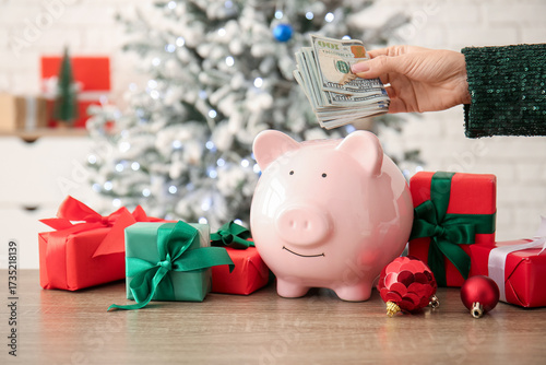 Female hand with money, pig...