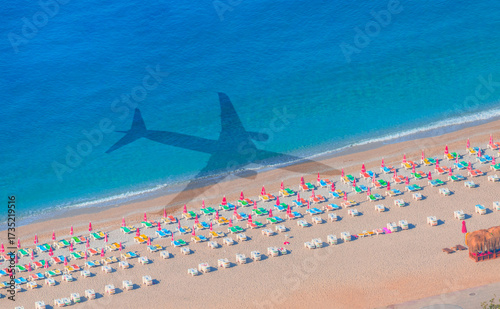 Fototapeta Naklejka Na Ścianę i Meble -  People sunbathing on the bach - Airplane travel to exotic destination with shadow of passenger airplane flying above beautiful tropical beach - Antalya, Turkey