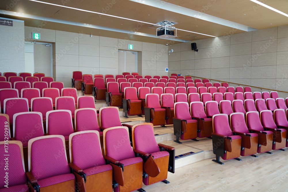 Naklejka premium Empty Conference Hall Auditorium with Red Chairs