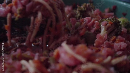 Close-up of a ladle scooping pickled vegetable curtido from a pot. Symbol of homemade cooking, culinary tradition, and fermented flavors.