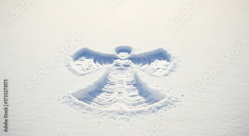 Delicate snow angel created in pristine white snow during winter.