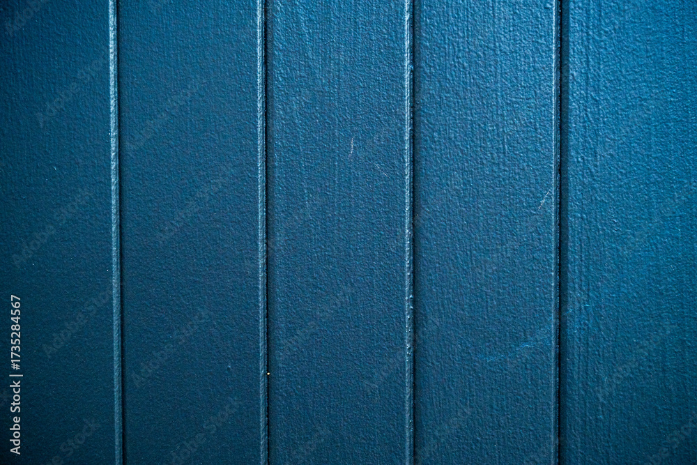 Fototapeta premium Closeup of a blue textured wall panel with vertical lines. High resolution abstract background ideal for design, layout, or architectural concepts.