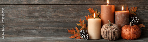 Thanksgiving wooden sign background with candles pumpkins pinecones and autumn leaves creates warm festive seasonal atmosphere