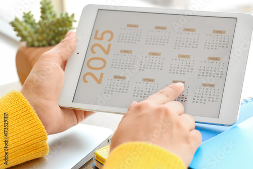 Female hands using calendar...