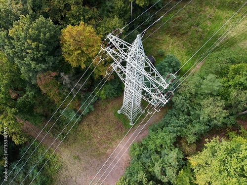 Aerial Drone View of High-Voltage Power Line Tower in Forest Landscape
