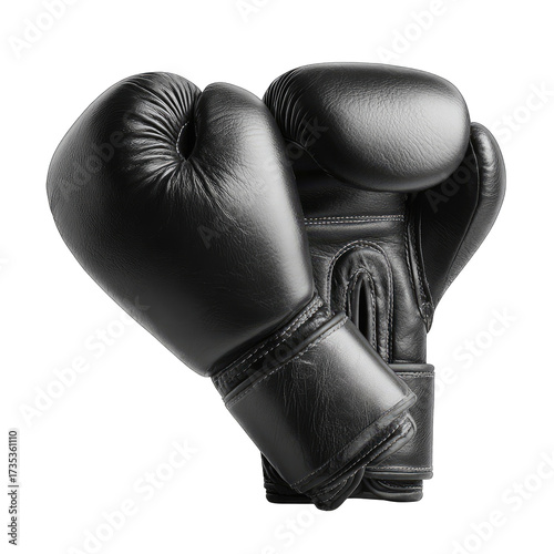 Pair of shiny black boxing gloves on dark, contrasting ground