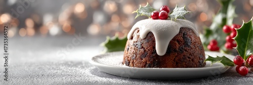 Christmas pudding with holly and icing on plate