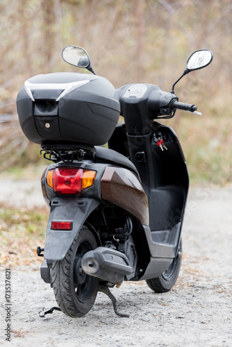 scooter of classic design with rounded shapes with a trunk for transporting things