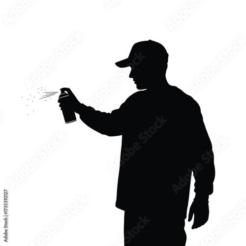 silhouette of a man spraying paint