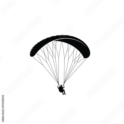 silhouette of a paraglider in the air