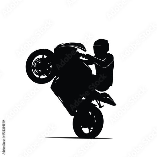 silhouette of a motorcyclist performing a wheelie on a sportbike