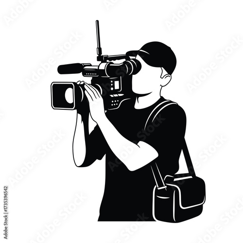 silhouette of a cameraman filming with a video camera