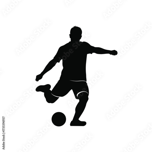 silhouette of a soccer player kicking ball
