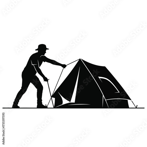 silhouette of a person setting up a tent
