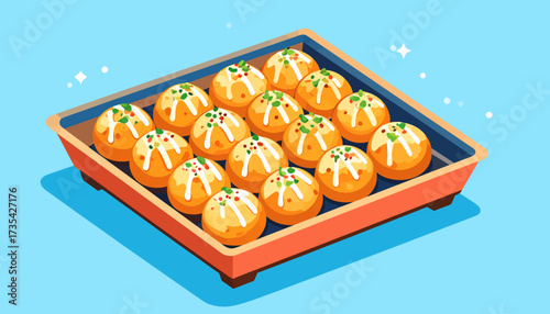 A tray of decorated round orange sweets.