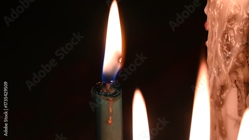 Candle flame close up on a dark background. Melted Wax Candle light border design. Burning at Night, Darkness. Candlelight.