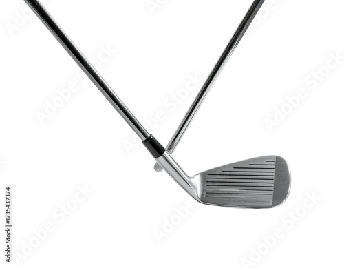 Two golf clubs intersecting, one resting on top of the other against a dark background
