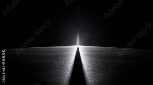 Wallpaper Mural Path of Light: A striking monochrome composition showcases a slender ray of light piercing through darkness, creating a dramatic contrast that evokes a sense of mystery and hope.  Torontodigital.ca