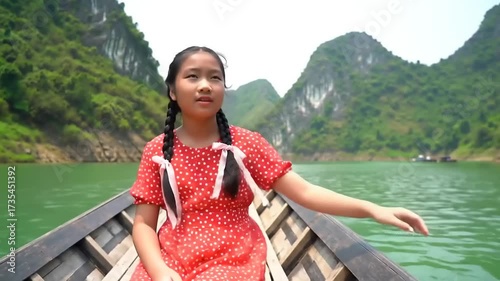 Young girl on boat exploring lake landscape with verdant mountains during daytime