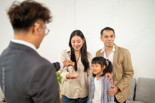 Fotografie Homeownership Dreams: A family, guided by an advisor, celebrates the fulfillment