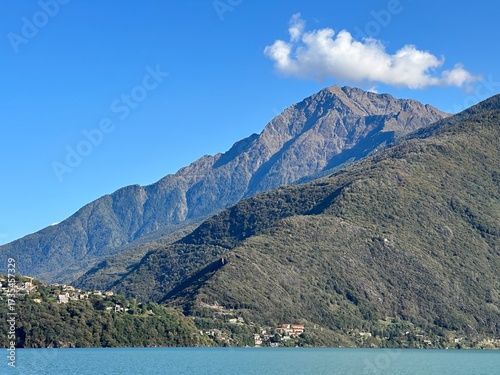 Majestic mountain landscape with lake Como and blue sky in sunlight, Dongo, Lombardy, Italy, October 2024