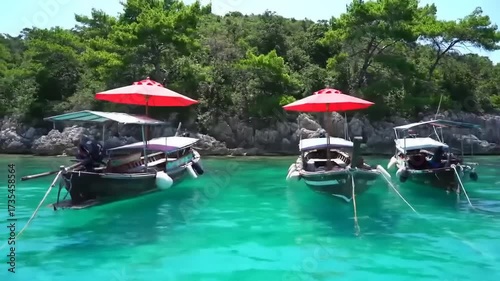 Boats on turquoise water with red umbrellas under sunny skies for vacation relaxation