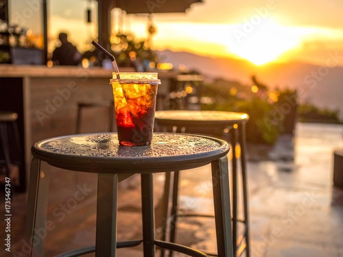 Iced tea on the table with a sunset view in the background