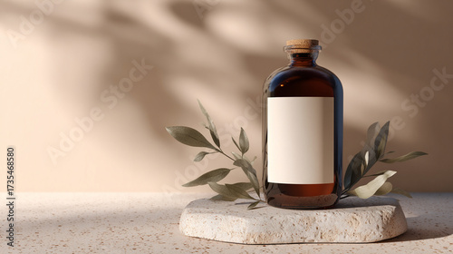 Modern botanical mockup: kombucha glass bottle with blank label on terrazzo slab, sprig of herbs beside it, soft studio shadows