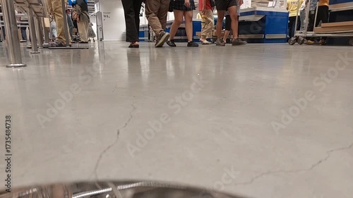 People Walking Indoors on Shiny Floor in Public Space