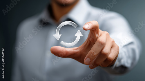Person in Business Attire Interacting with Digital Refresh Symbol Signifying Data or Process Update in Modern Office Environment