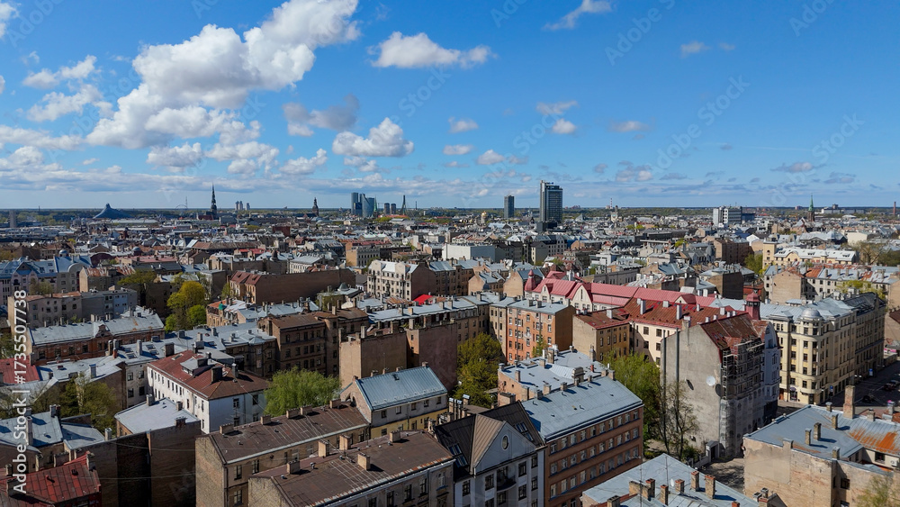 Fototapeta premium Aerial Drone View Of Riga Panorama In Latvia On A Sunny Spring Day Showcasing The Rooftops Of Houses The Vibrant City Center Historic Buildings And Barona Street Playground of the Downtown Sports Area