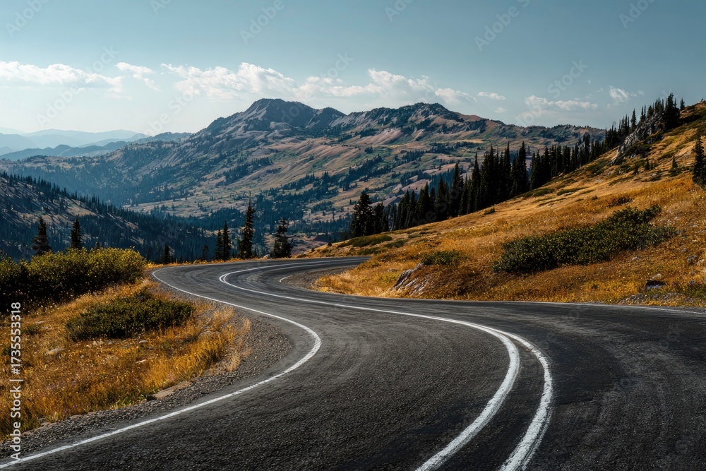 Naklejka premium A winding mountain road leads through a stunning landscape with vast views