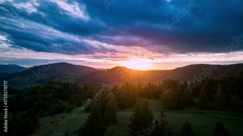 Hyperlapse aerial view of vibrant sunset sky over mountain forest , carpathians landscape