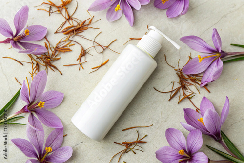 Blank White Cosmetic Pump Bottle with Saffron Crocus Flowers and Stigmas for Skincare Product Mockup