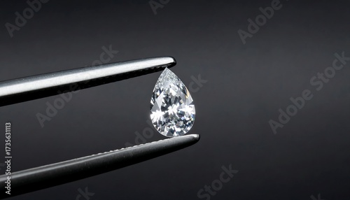 Pear-shaped diamond held by tweezers (3)