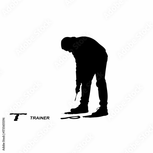 Silhouette of trainer drawing letters on dirt ground with stick isolated on white background