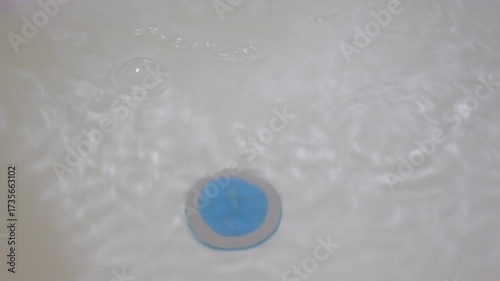 Bubbles on the surface of water in the bathtub.
