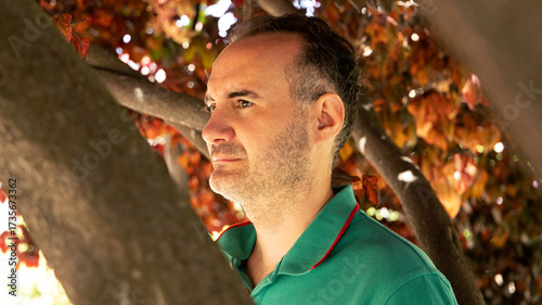 profile portrait of a man among autumn leaves